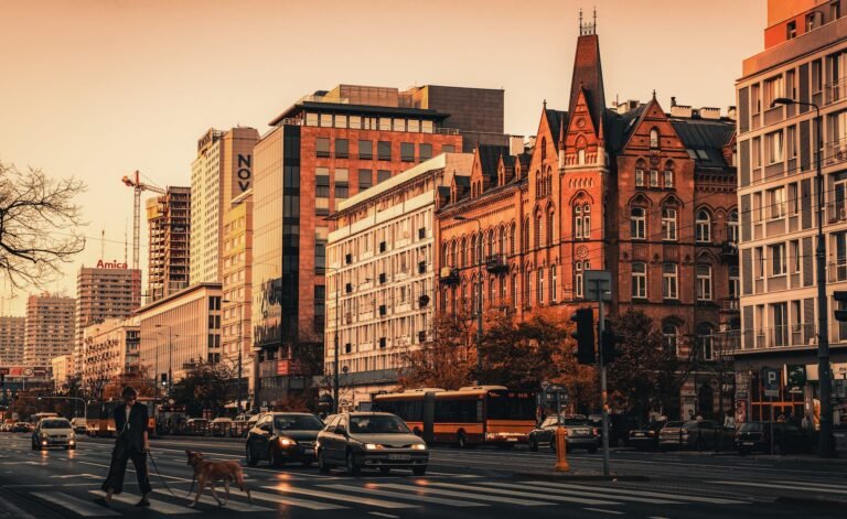 a man crossing street with his dog