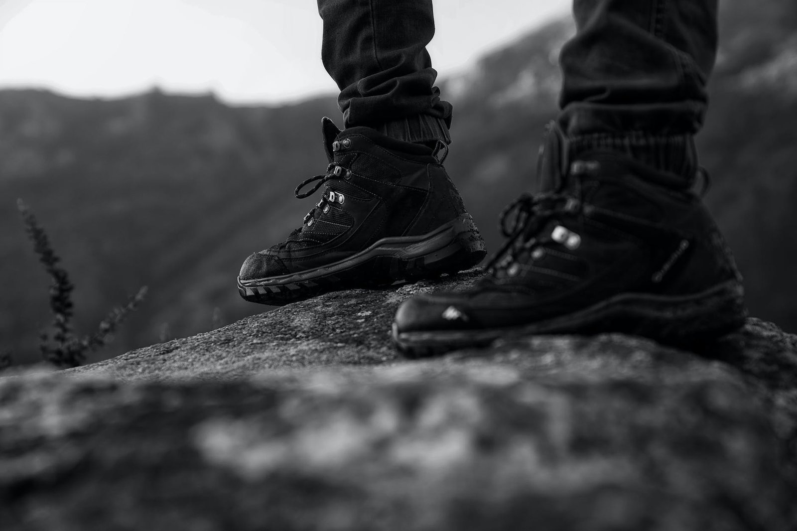 monochrome photo of person wearing black shoes