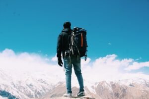 photo of man standing on top of mountain