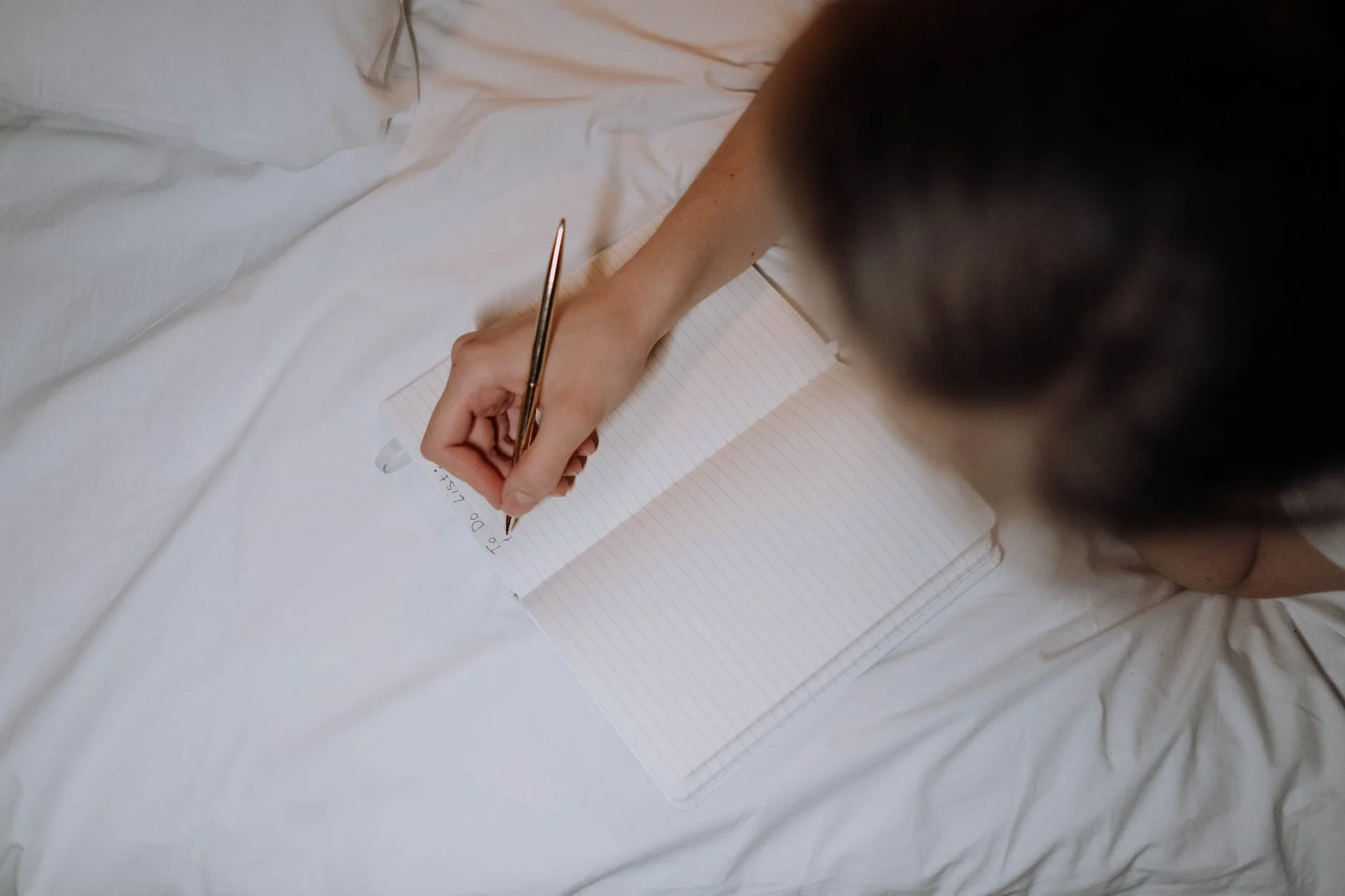 a person writing on a notebook