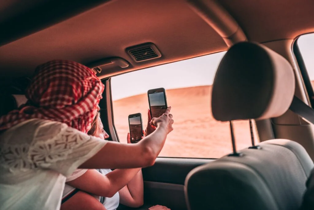 people taking photo of the desert