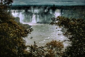 photo of the iguazu waterfall a lake and boats in brazil and argentina